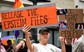 People hold signs calling for the release of files regarding late sex offender Jeffrey Epstein participate in a protest as part of the 'Good Trouble Lives On' national day of action against the administration of US President Donald Trump in Houston, Texas, on July 17, 2025. US President Donald Trump blasted his own supporters and "stupid" Republicans on July 16, 2025, as he went on the attack against anyone questioning his administration's handling of the case of dead sex criminal Jeffrey Epstein. Trump is facing the most serious split in his loyal right-wing base since he returned to power, over claims that his administration is covering up lurid details of disgraced financier Epstein's crimes to protect rich and powerful figures. Epstein died by suicide in a New York prison in 2019 -- during Trump's first term -- after being charged with sex trafficking in a scheme where he allegedly groomed young and underage women for sexual abuse by the rich and powerful. (Photo by RONALDO SCHEMIDT / AFP)