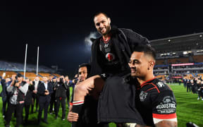 Simon Mannering is carried from the field by team mates David Fusitua and Ken Maumalo after playing his 300th match.