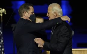 In this file photo taken on November 07, 2020 US President-elect Joe Biden (R) embraces his son Hunter Biden (L) on stage after delivering remarks in Wilmington, Delaware.