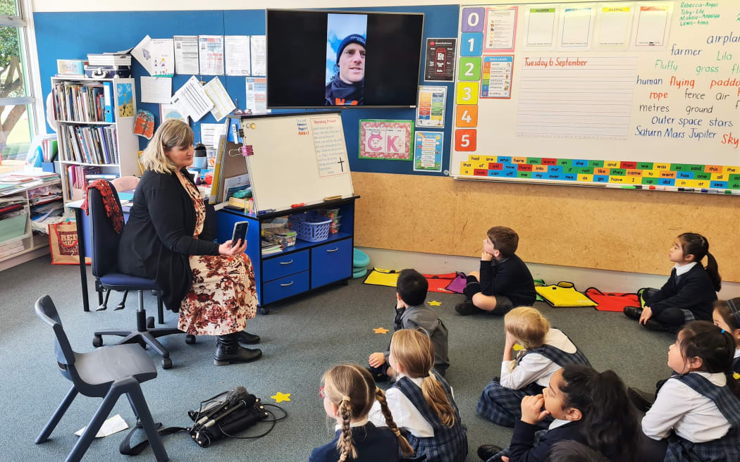 Teacher Brigid Ladley and farmer Pat Crawshaw (on the screen) with Year 2 students at St Michael's Church School