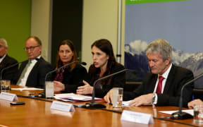Prime Minister Jacinda Ardern, centre, announces the government's decision to attempt to eradicate the cattle disease