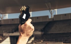 Close up of hand firing a starter pistol to start the running race. Athletes starting off for a race on a running track.