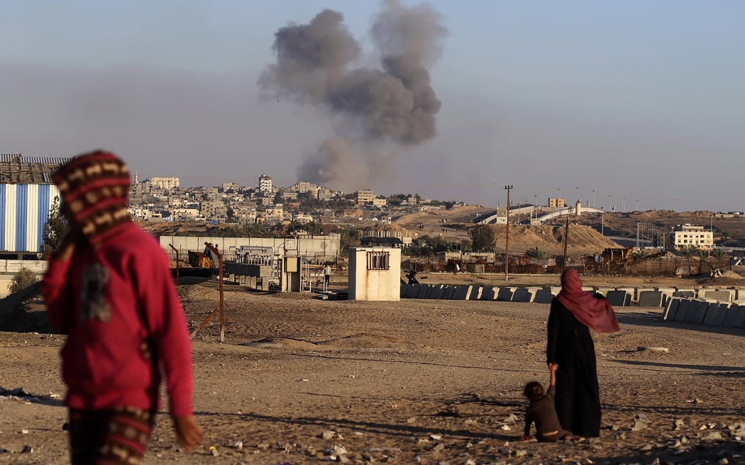 Smoke rises following an Israeli airstrike on buildings near the separating wall between Egypt and Rafah, southern Gaza Strip, on Tuesday, 7 May, 2024.