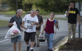 Evacuees make their way to a bus, taking them to a shelter further inland, after a local shelter filled up, a day before the arrival of Hurricane Florence in Wilmington, North Carolina.