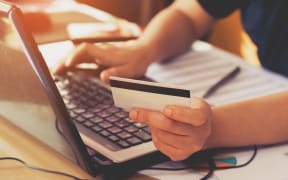 A person doing an online payment using a credit / debit card.