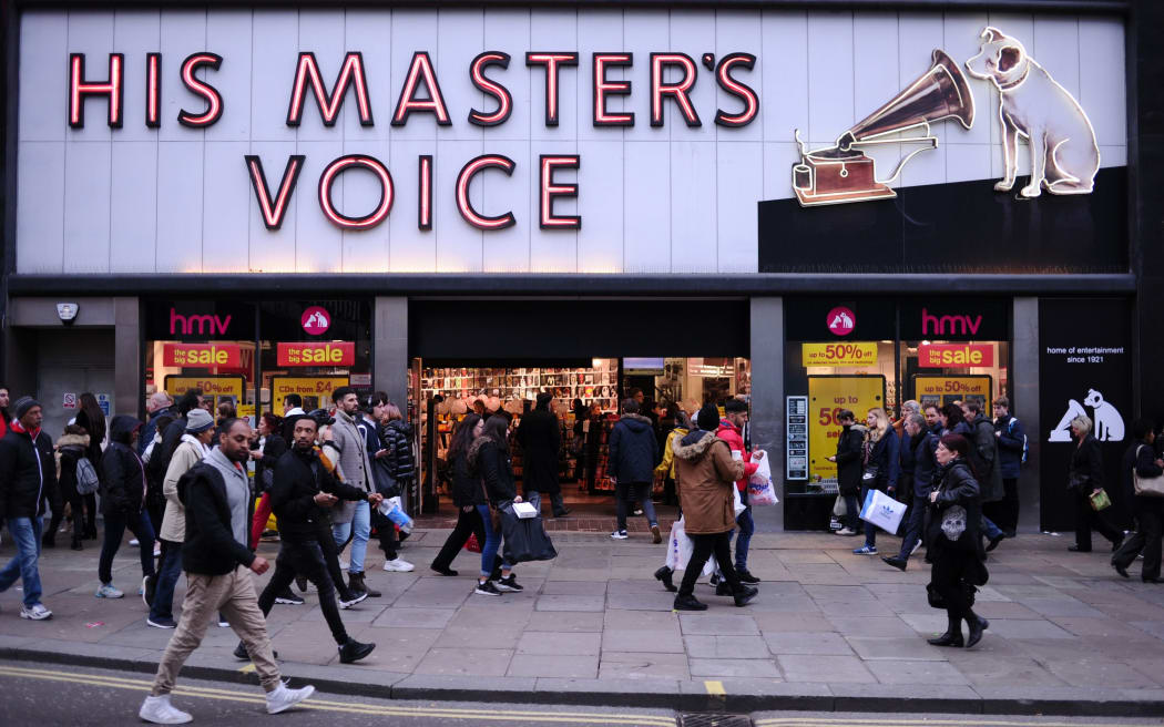 Sales shoppers pass a branch of troubled retailer HMV on Oxford Street in London, England, on December 28, 2018.