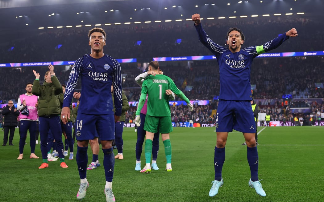Paris Saint-Germain players Desire Doue (L) and Marquinhos celebrate after their Champions League quarter-final second-leg match against Aston Villa.