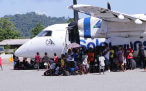 Seghe community escapes the heat at the new runway opening ceremony.