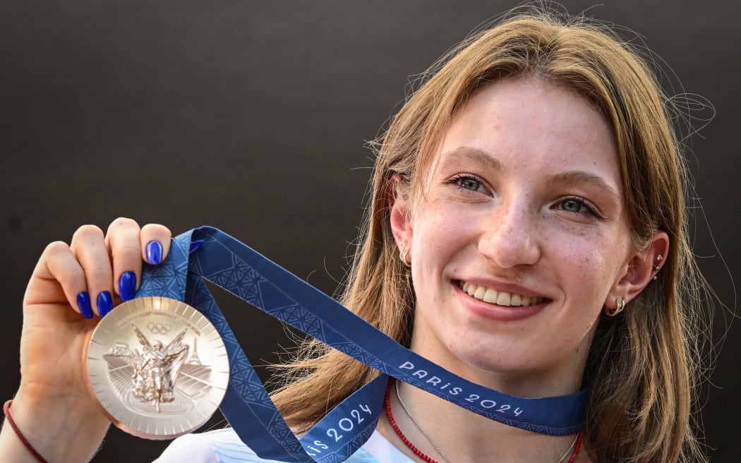 Romanian gymnast Ana Maria Barbosu poses with her Olympic bronze medal she was given after the Paris Olympics US gymnast Jordan Chiles was stripped of it.