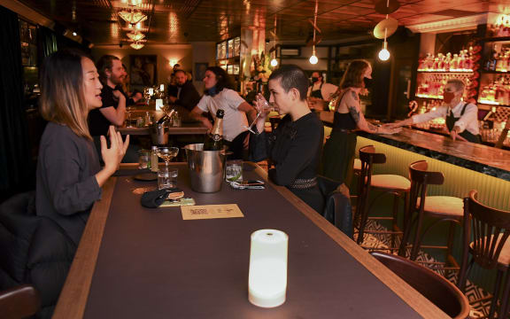 Patrons enjoy a drink in Nick & Nora's bar at a midnight opening in Melbourne on October 28, 2020 after the state government lifted some of the city's harsh restrictions.