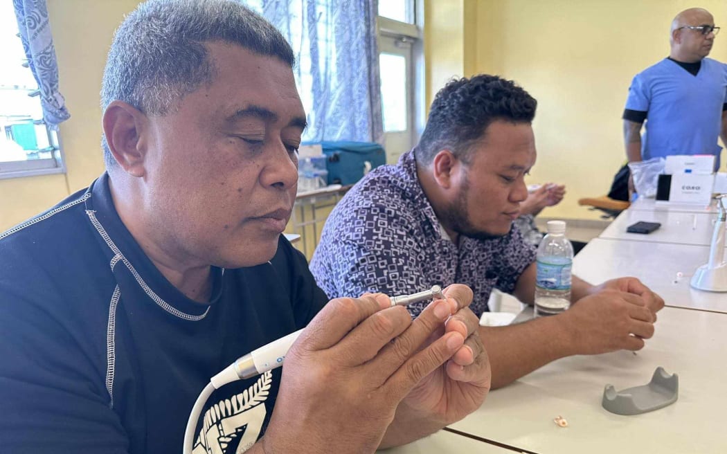 Tongan dentists practicing root canals during the course.