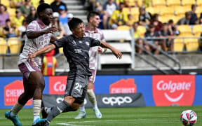 Wellington Phoenix player Kazuki Nagasawa, right, is challenged by Hosine Bility of the Brisbane Roar during the men's A-League match at Sky Stadium, Wellington, 6 February 2025.