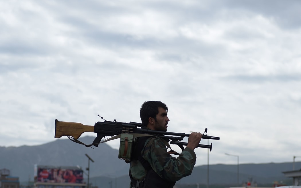Afghan security personnel keep watch after a car bomb attack in Kabul.