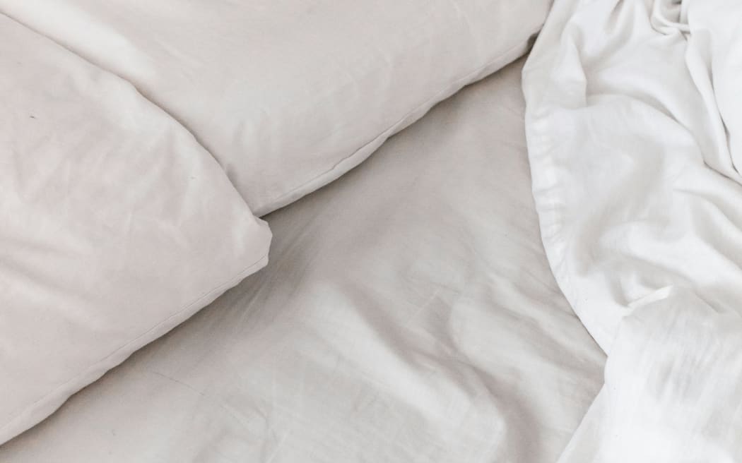 White sheets and pillows on a bed