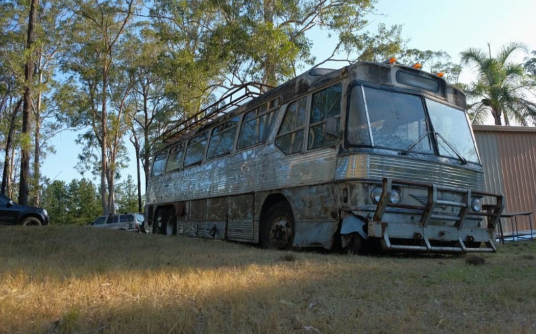 The Priscilla Queen of the Desert bus sitting in a paddock.