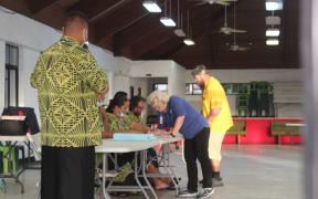Electors sign the voter roll before casting ballots at the Ili’ili village polling station, today, during the American Samoa General
election. 4 November 2020