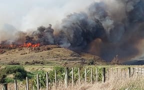 Smoke from a vegetation fire on Waikawa Beach Road in Horowhenua, seen from a neighbouring property.
