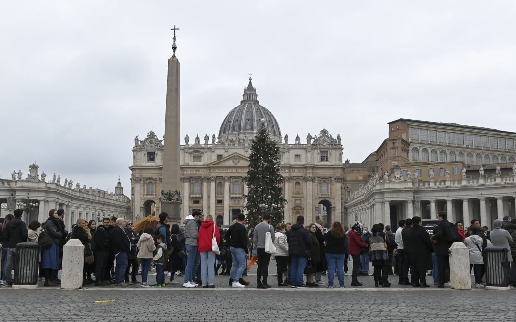 People wait in a line to enter Saint Peter's Basilica at the Vatican where late Pope Benedict 16 is being laid in state at The Vatican, Monday, Jan. 2, 2023. Benedict XVI, the German theologian who will be remembered as the first pope in 600 years to resign, has died, the Vatican announced Saturday. He was 95.