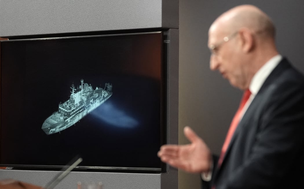 Britain's Defence Secretary John Healey, backdropped by a screen displaying an image of Russian military ship Yantar, operating off the northern coast of Scotland, delivers a speech in the Downing Street briefing room in central London on November 19, 2025. UK Defence Secretary John Healey said Wednesday that the Russian military ship Yantar had entered British waters and directed lasers at British pilots. "The Yantar is on the edge of UK waters, north of Scotland, having entered the UK's wider waters over the last few weeks," he told reporters, warning Russian President Vladimir Putin should the ship travel further south: "We are ready." (Photo by Stefan Rousseau / POOL / AFP)