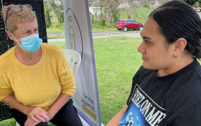 Paea Uiloa, right, speaks to vaccinator before vaccination