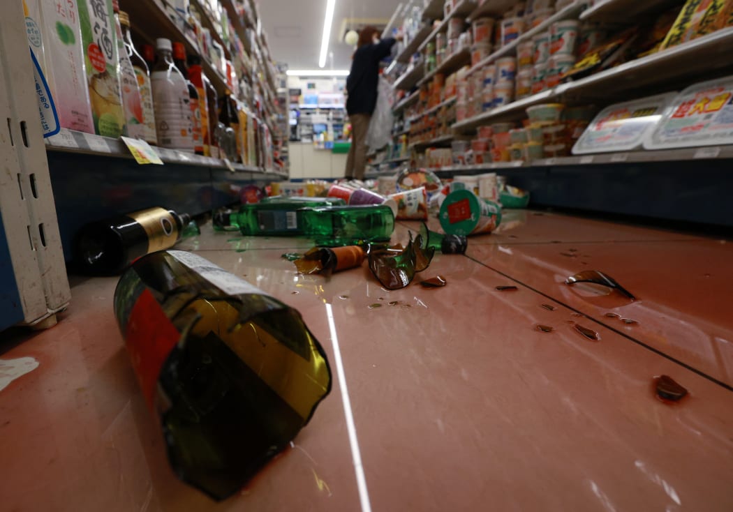 Wine and sake bottles are scattered  by a massive earthquake at a covenient store in Ishinomaki, Miyagi Prefecture on Feb. 13, 2021.