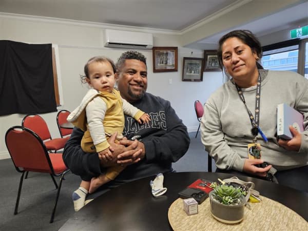 Semi Ratuniyauravu with his baby (Viliame Ratuniyauravu) in his arms and Percy Tilialo, Pacific Outreach Navigator, Tangata Atumotu Trust (right).