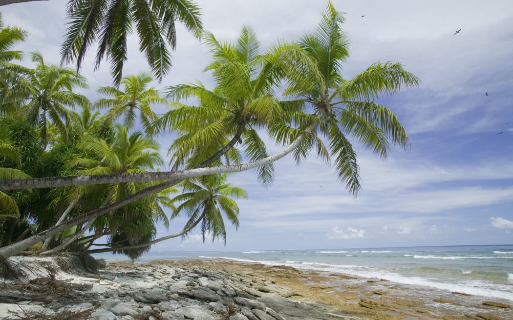 A Tuvalu beach being eroded by a storm.