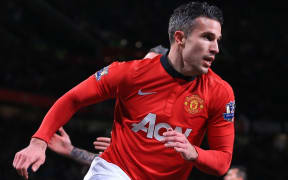 Robin van Persie of Man Utd peels away as he celebrates after scoring.