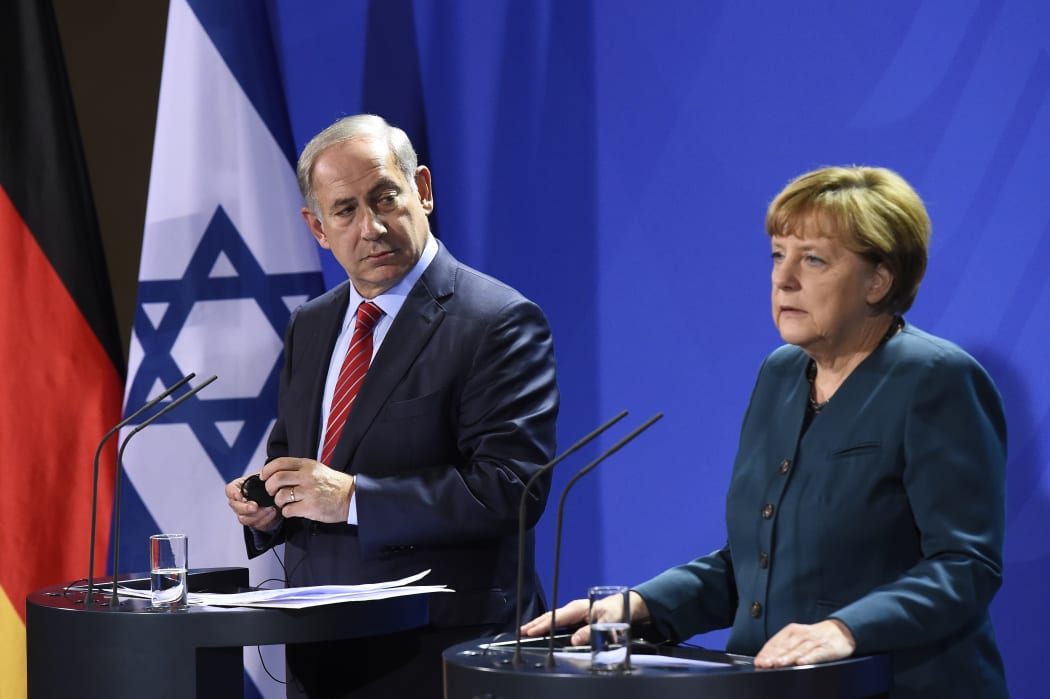 Benjamin Netanyahu and Angela Merkel addressing a media conference in Berlin.
