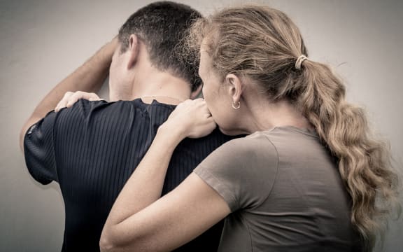 Sad woman hugging her husband