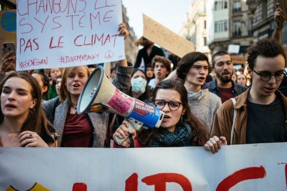 Strike against climate change. Fridays for the climate. Youth march with Greta Thunberg in support of the French students. Girl with megaphone. Paris, February 22, 2019.