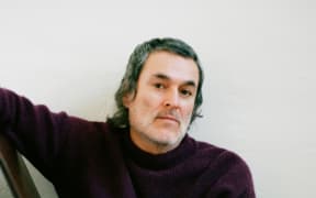 Man in a woolly jersey looking at the camera