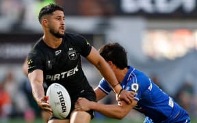 Dylan Brown of the Kiwis offloads the ball.