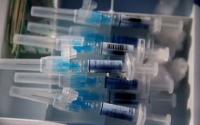 Syringes filled with flu vaccine (California).