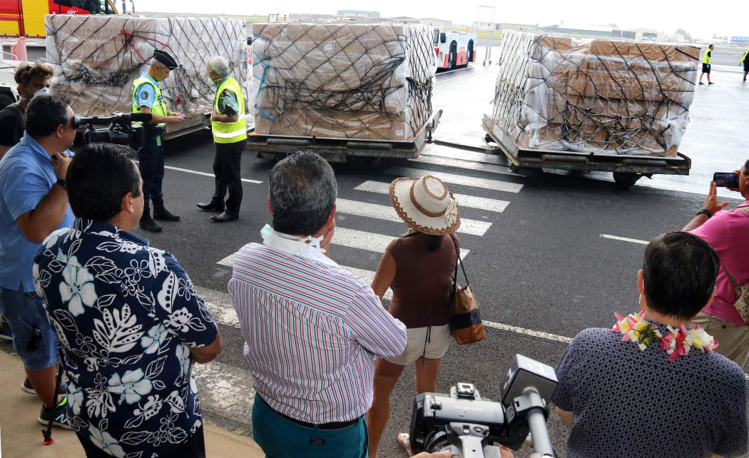 Supplies are brought off the flight from China