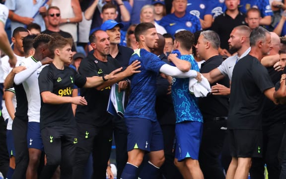 Chelsea Manager Thomas Tuchel is shielded by players as Tottenham Hotspur Manager Antonio Conte is held back from speaking with him, 2022.