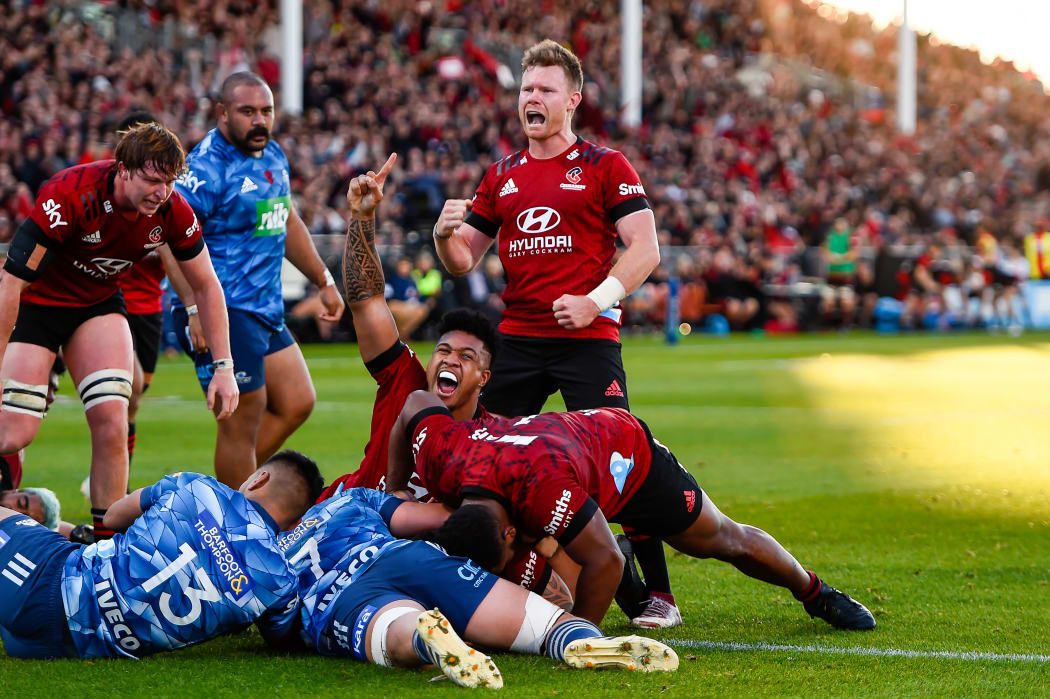 Leicester Faingaanuku (on ground) and Mitchell Drummond of the Crusaders celebrates Codie Taylor of the Crusaders try during the Super Rugby Aotearoa rugby match, Crusaders V Blues