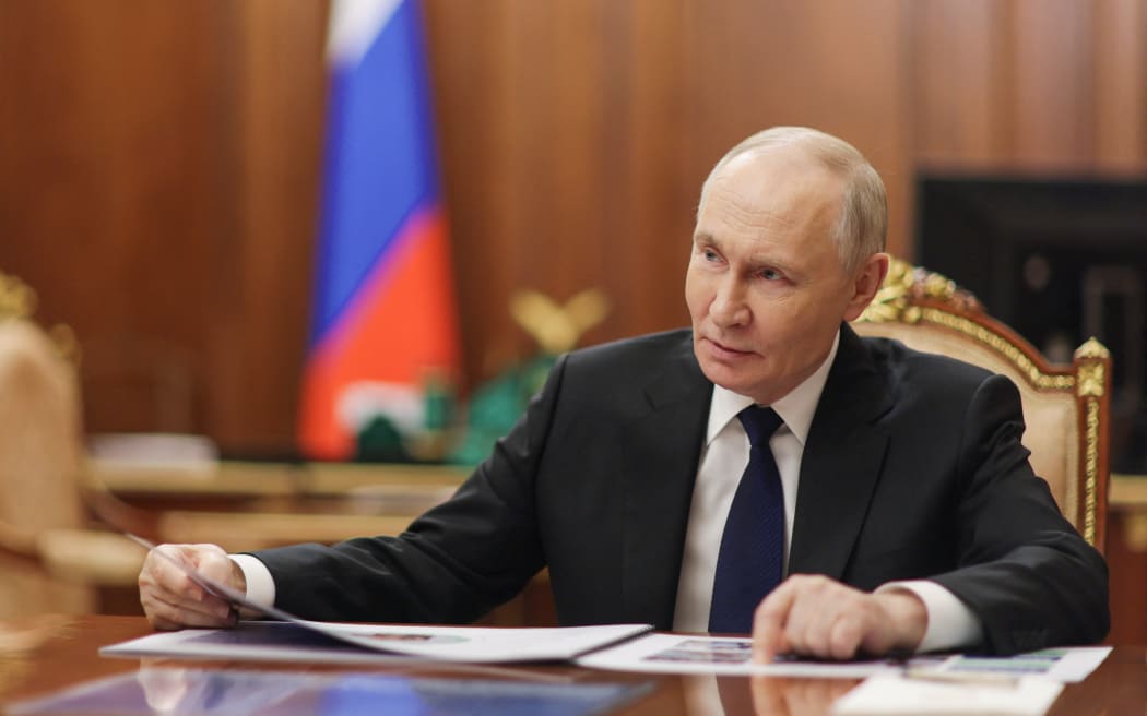 In this pool photograph distributed by the Russian state agency Sputnik, Russia's President Vladimir Putin attends a meeting with Deputy Defence Minister and Chair of Defenders of the Fatherland Foundation in Moscow on December 30, 2025.