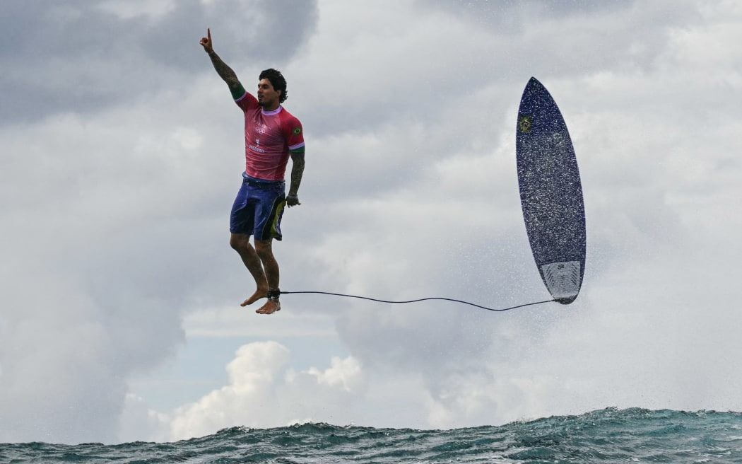 Brazil's Gabriel Medina reacts after getting a large wave at the men's Olympic surfing event in Tahiti.