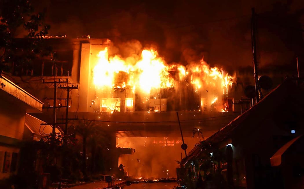 A major fire burns through the Grand Diamond City hotel-casino in Poipet on December 29, 2022.