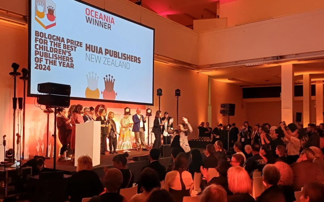 Eboni Waitere receiving the Best Children's Publishers of the Year, Oceania, at the Bologna Children's Book Fair in Italy.