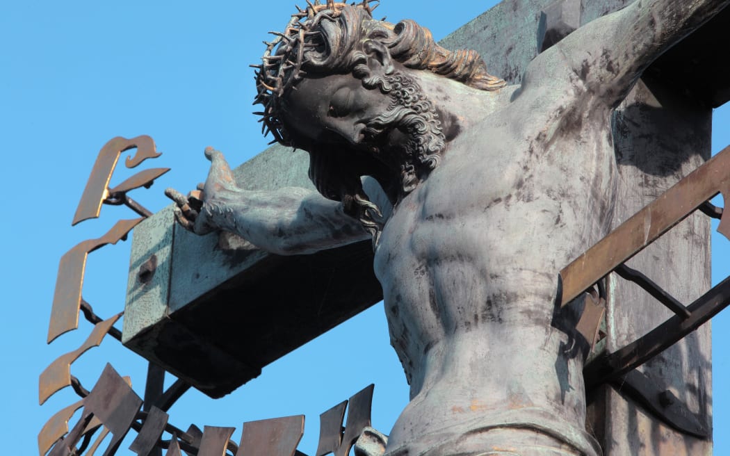 Detail of the Crucifix and Calvary sculpture, installed 1657, on the Charles Bridge or Karluv most over the Vltava river, Prague, Czech Republic. Bought in Dresden, this crucifix was originally made in 1629 by H Hillger after a design by W E Brohn.