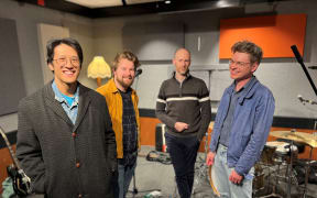 Best bets stand in a row in front of their gear in the Christchurch RNZ Studio. The band is four men who look as though they are in their 20s.