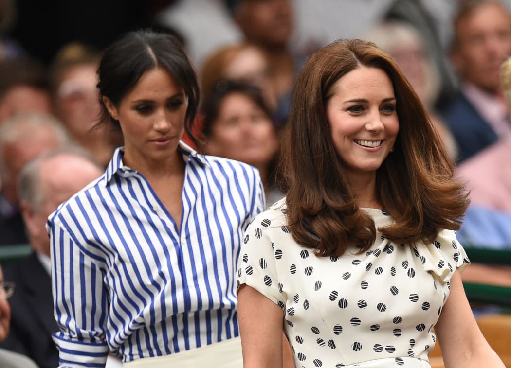 Catherine, Duchess of Cambridge, and Meghan, Duchess of Sussex take their seats at the 2018 Wimbledon Championships