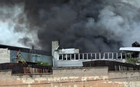 ODESA, UKRAINE - JULY 16, 2022 -  A plume of smoke rises above a commercial and industrial warehouse hit by a Russian rocket, Odesa, southern Ukraine. This photo cannot be distributed in the Russian Federation. NO USE RUSSIA. NO USE BELARUS. (Photo by Nina Liashonok / NurPhoto via AFP)