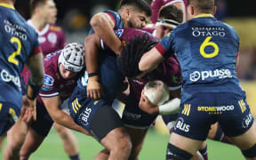 Brandon Paenga-Amosa is tackled.
Highlanders v Reds, Sky Super Rugby Trans-Tasman, Round 1. Forsyth Barr Stadium, Dunedin, New Zealand. Friday 14 May 2021. Â© Copyright photo: Derek Morrison / www.photosport.nz