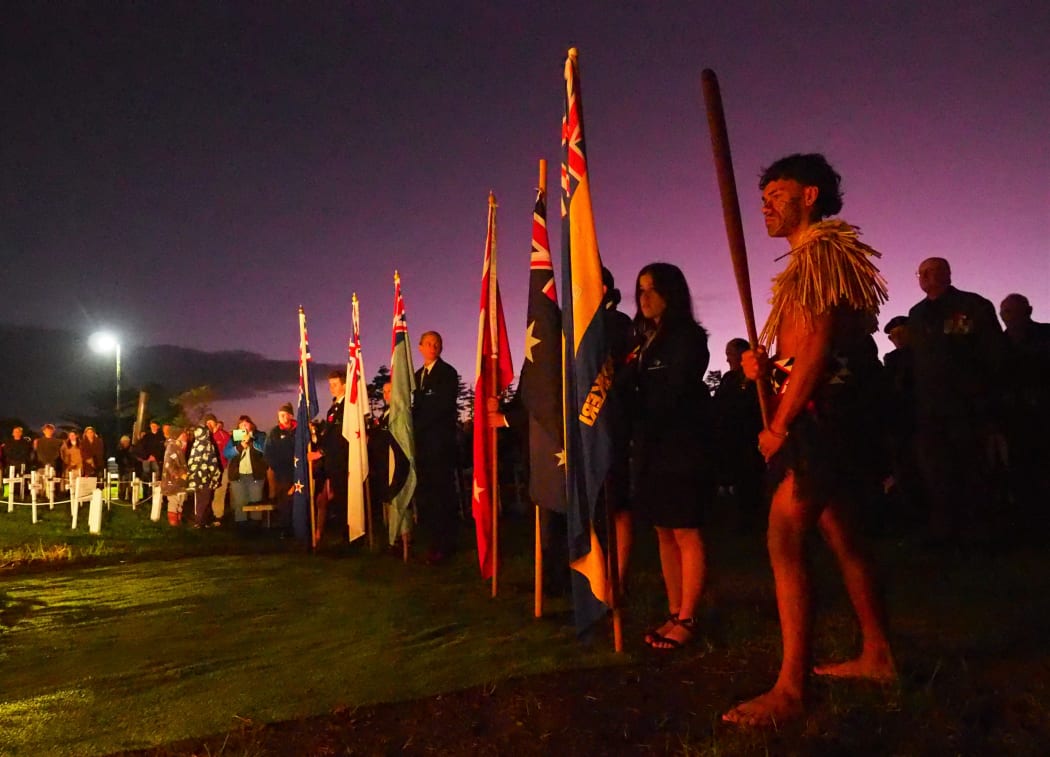 Joshua-James Young, of Kerikeri High School’s kapa haka group Te Pou o Manakō, stands guard over the flag bearers during Kerikeri's dawn service.