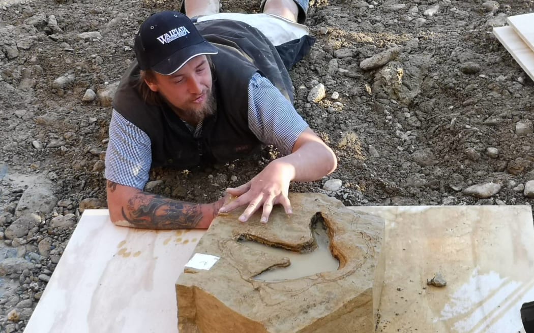 Michael Johnston and a moa footprint.