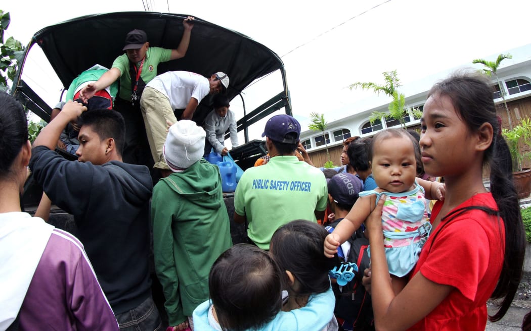 Residents are evacuated to a safer place in Legazpi City, southeast of Manila, ahead of the arrival of Typhoon Hagupit.