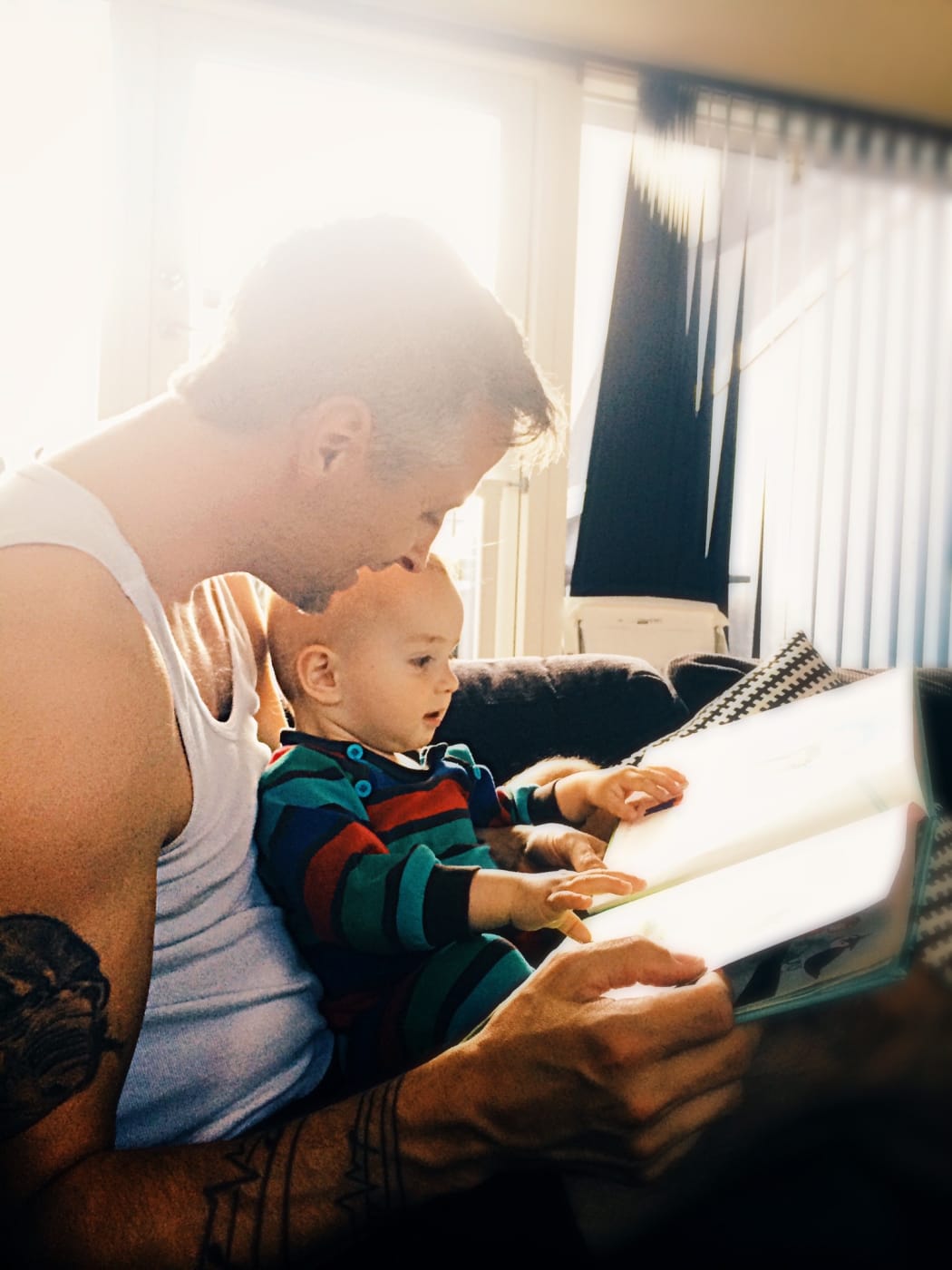 Father reading to baby son